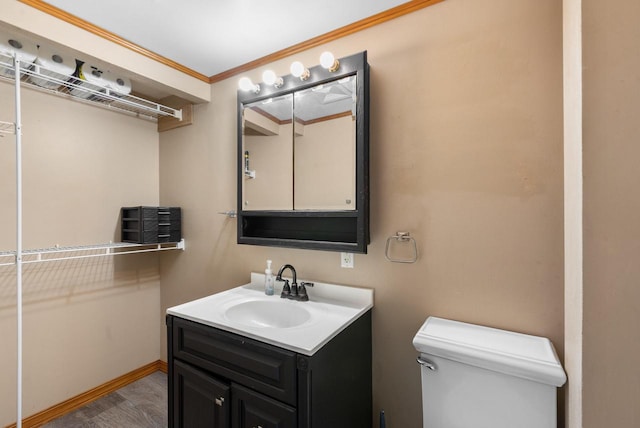 1439 Parkview Dr, Kewaskum, WI 53040 - half bathroom with vanity, toilet, wood finished floors, ornamental molding, and baseboards