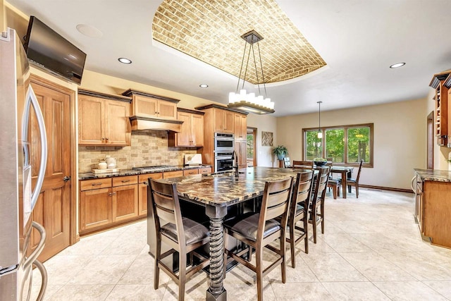 1830 Pine Tree Ct, Luxemburg, WI 54217 - kitchen with a raised ceiling, appliances with stainless steel finishes, light tile patterned floors, backsplash, and baseboards