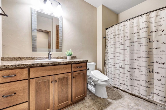 1830 Pine Tree Ct, Luxemburg, WI 54217 - full bath featuring toilet, vanity, tile patterned floors, and a shower with shower curtain