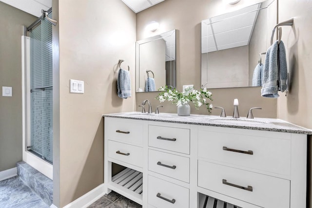 1830 Pine Tree Ct, Luxemburg, WI 54217 - full bath featuring double vanity, baseboards, a shower with door, and marble finish floors