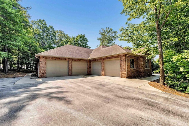 1830 Pine Tree Ct, Luxemburg, WI 54217 - view of front of house featuring a garage, brick siding, and driveway