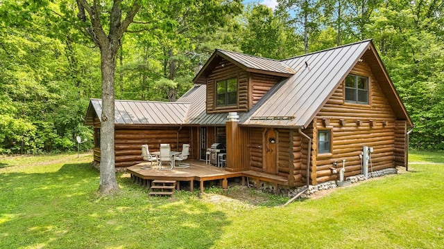 E1424 N Lake Rd, Iola, WI 54945 - back of house featuring a standing seam roof, log siding, a lawn, and a wooden deck