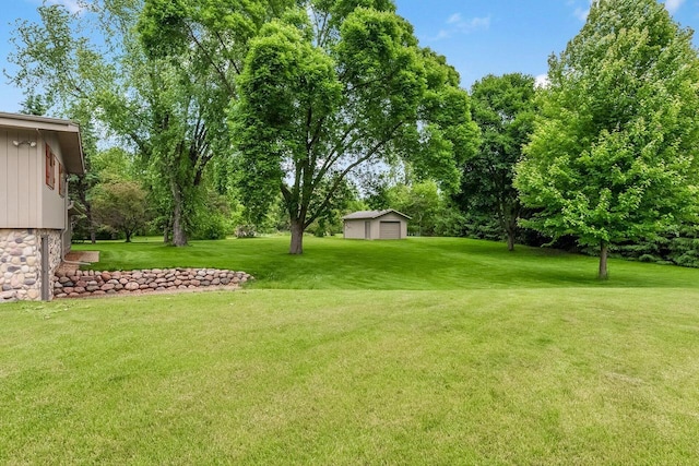 N9570 Sunset Dr, East Troy, WI 53120 - view of grassy yard featuring an outdoor structure and view of wooded area
