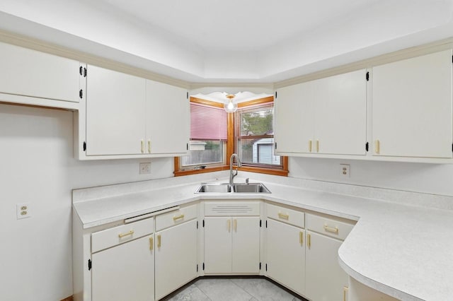 4349 N 80th St, Milwaukee, WI 53222 - kitchen featuring a sink, light countertops, light tile patterned flooring, and white cabinets