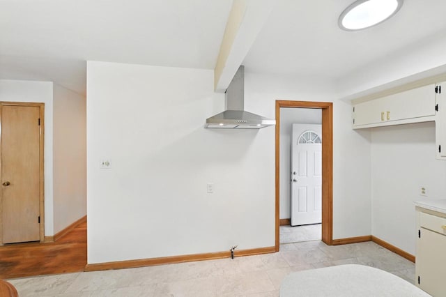 4349 N 80th St, Milwaukee, WI 53222 - kitchen featuring wall chimney exhaust hood, baseboards, light countertops, and white cabinets
