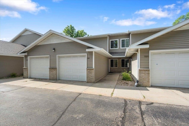 5118 Walbridge Ave, Madison, WI 53714 - view of property with an attached garage, brick siding, and driveway