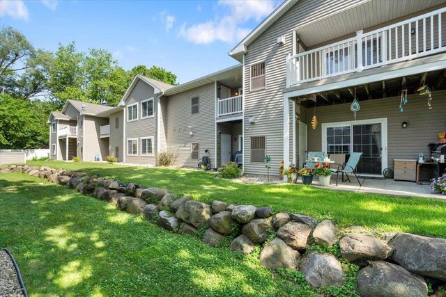 5118 Walbridge Ave, Madison, WI 53714 - rear view of property featuring a balcony, a lawn, and a patio