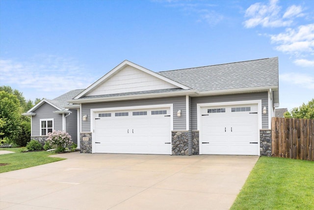4835 W Jack Pine Ct, Appleton, WI 54913 - craftsman-style house with stone siding, roof with shingles, a garage, and driveway