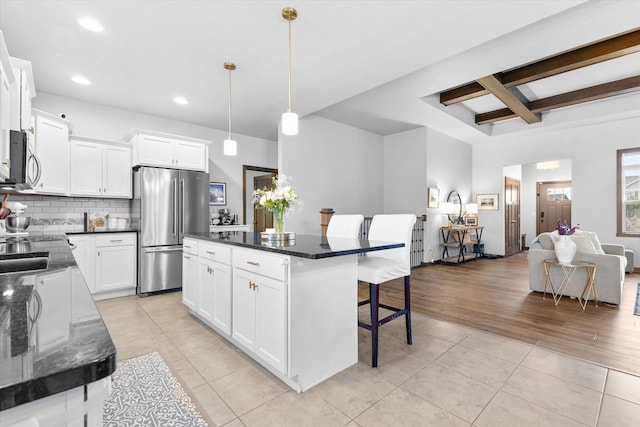 4835 W Jack Pine Ct, Appleton, WI 54913 - kitchen with appliances with stainless steel finishes, a breakfast bar area, light tile patterned floors, dark countertops, and recessed lighting