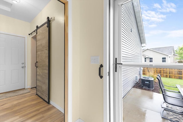 4835 W Jack Pine Ct, Appleton, WI 54913 - corridor with a barn door, wood finished floors, and baseboards