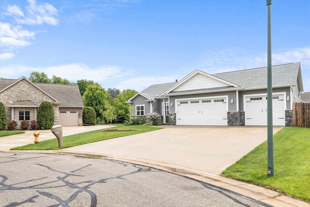 4835 W Jack Pine Ct, Appleton, WI 54913 - view of front facade featuring stone siding, an attached garage, driveway, and a shingled roof
