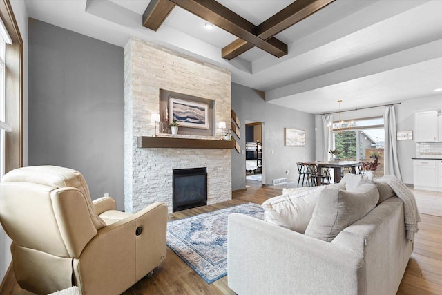 4835 W Jack Pine Ct, Appleton, WI 54913 - living room featuring coffered ceiling, beamed ceiling, a fireplace, baseboards, and a chandelier