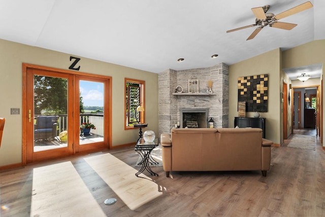 N2068 Alphorn Rd, Monroe, WI 53566 - living area with wood finished floors, a fireplace, a ceiling fan, and vaulted ceiling