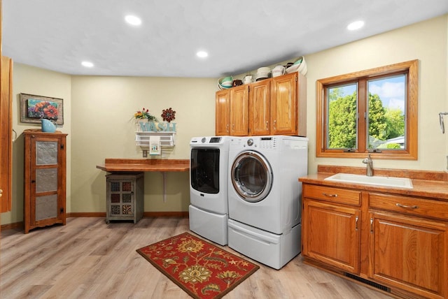 N2068 Alphorn Rd, Monroe, WI 53566 - washroom featuring independent washer and dryer, cabinet space, light wood finished floors, and recessed lighting