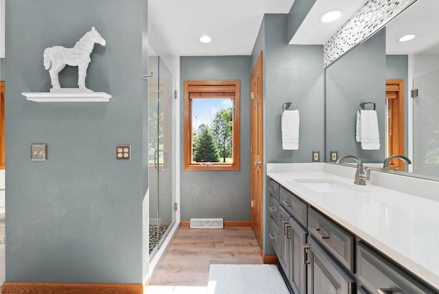 N2068 Alphorn Rd, Monroe, WI 53566 - bathroom with vanity, wood finished floors, a shower stall, and recessed lighting
