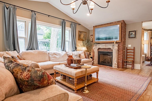 72 W Mill St, Winona, MN 55987 - living room with vaulted ceiling, a chandelier, wood finished floors, a brick fireplace, and recessed lighting