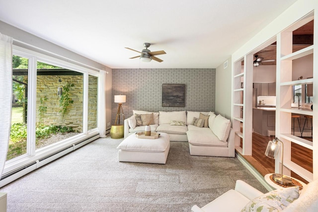 1418 Mill Rd, Delafield, WI 53018 - carpeted living area featuring ceiling fan, brick wall, and a baseboard radiator