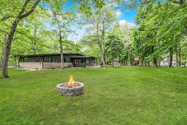1418 Mill Rd, Delafield, WI 53018 - view of green lawn with a sunroom and a fire pit
