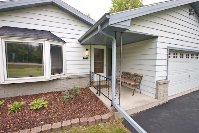 11426 W Woods Rd, Franklin, WI 53132 - doorway to property with a garage and a porch