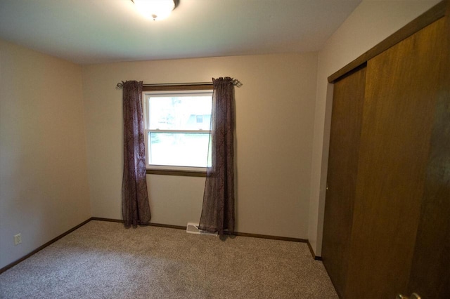 11426 W Woods Rd, Franklin, WI 53132 - unfurnished bedroom featuring light colored carpet, baseboards, and a closet