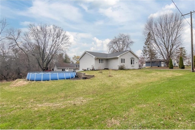 222 1st Ave, Clear Lake, WI 54005 - back of house featuring an outdoor pool and a lawn