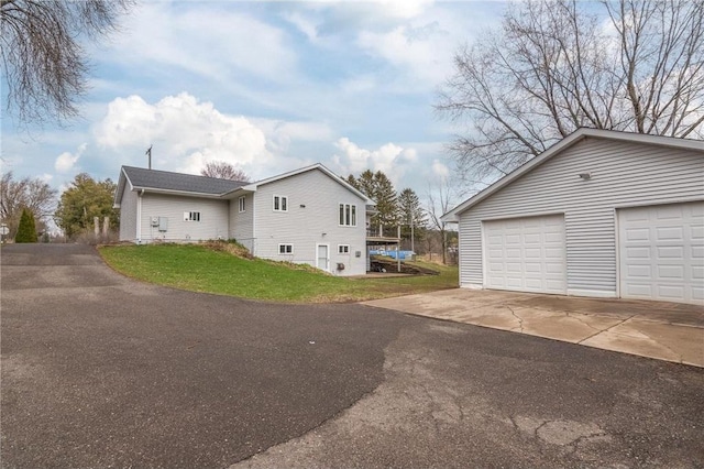 222 1st Ave, Clear Lake, WI 54005 - view of side of property featuring a lawn and a garage