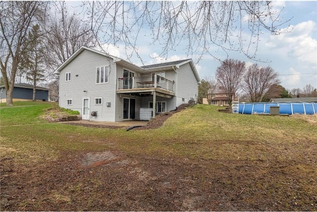 222 1st Ave, Clear Lake, WI 54005 - rear view of property featuring a lawn, an outdoor pool, and a wooden deck