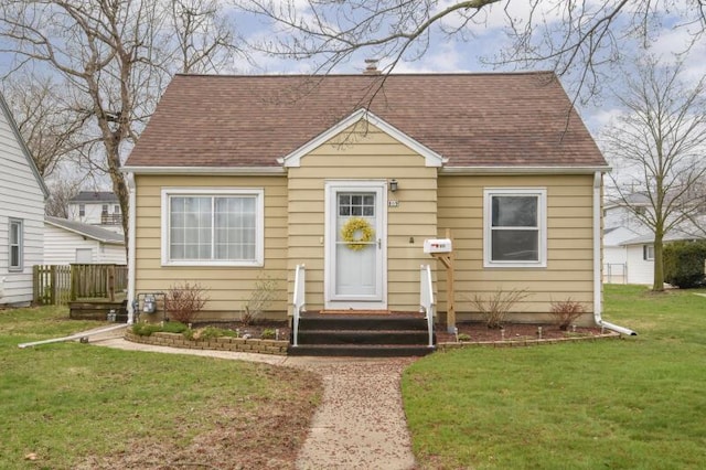 809 S 113th St, West Allis, WI 53214 - view of front facade with roof with shingles and a front yard