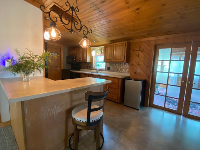 8001 Waschbisch Rd, Oconto Falls, WI 54154 - kitchen featuring wood ceiling, a peninsula, freestanding refrigerator, light countertops, and french doors