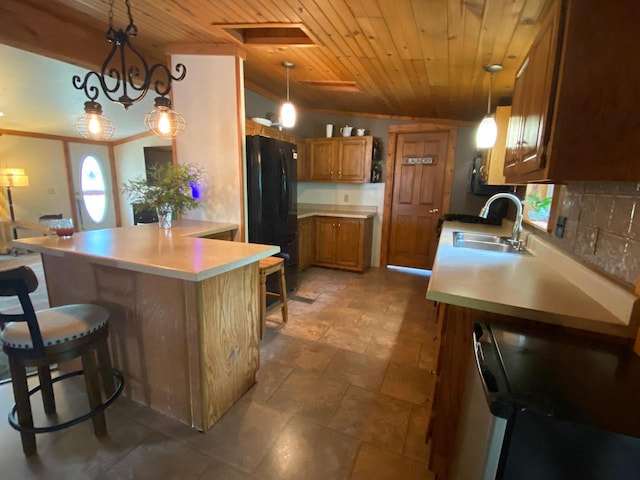 8001 Waschbisch Rd, Oconto Falls, WI 54154 - kitchen featuring freestanding refrigerator, a sink, wooden ceiling, brown cabinetry, and a peninsula
