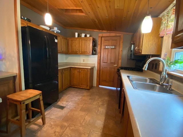 8001 Waschbisch Rd, Oconto Falls, WI 54154 - kitchen with freestanding refrigerator, wooden ceiling, brown cabinets, a sink, and pendant lighting
