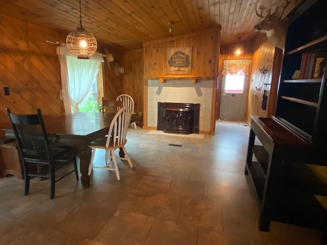 8001 Waschbisch Rd, Oconto Falls, WI 54154 - dining room with wood walls, wood ceiling, and a tile fireplace