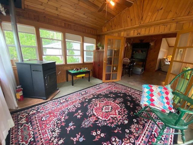 8001 Waschbisch Rd, Oconto Falls, WI 54154 - living area featuring lofted ceiling, wood walls, ceiling fan, a wood stove, and wood ceiling