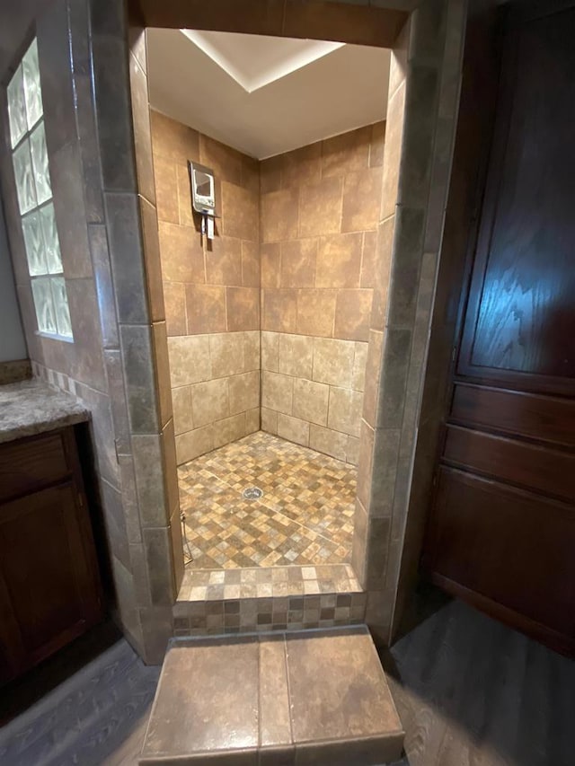 8001 Waschbisch Rd, Oconto Falls, WI 54154 - full bathroom with tiled shower, vanity, and wood finished floors