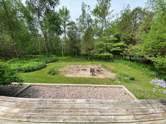 8001 Waschbisch Rd, Oconto Falls, WI 54154 - view of green lawn featuring an outdoor fire pit and a deck