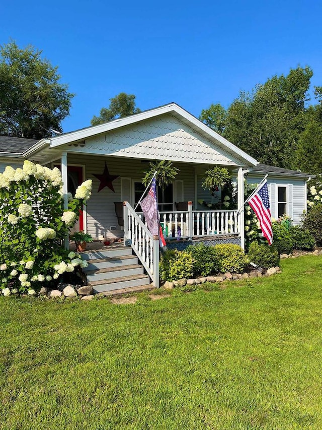 8001 Waschbisch Rd, Oconto Falls, WI 54154 - view of front of property with covered porch and a front yard