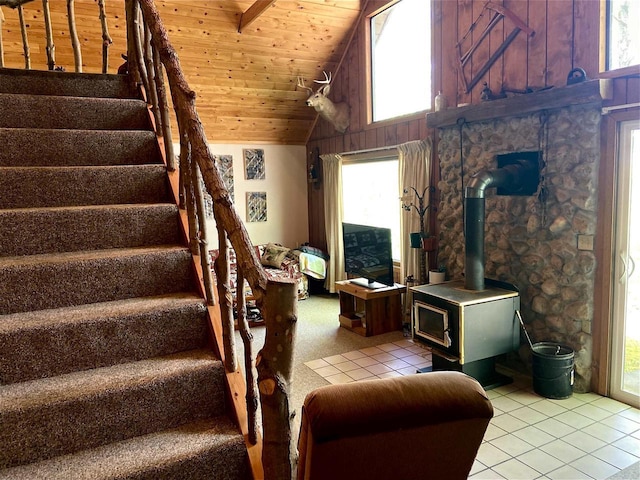 16651 Dolittle Ln, Townsend, WI 54175 - staircase with a wood stove, wooden ceiling, vaulted ceiling, and tile patterned floors
