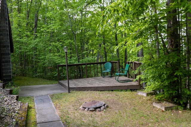 16651 Dolittle Ln, Townsend, WI 54175 - wooden terrace with a fire pit and a view of trees
