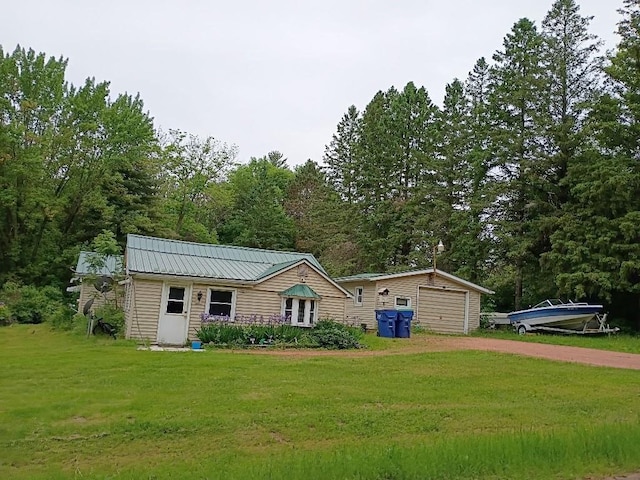 15380 Brandenburg Ave, Merrill, WI 54452 - view of front of property with dirt driveway, a front lawn, metal roof, and an outdoor structure