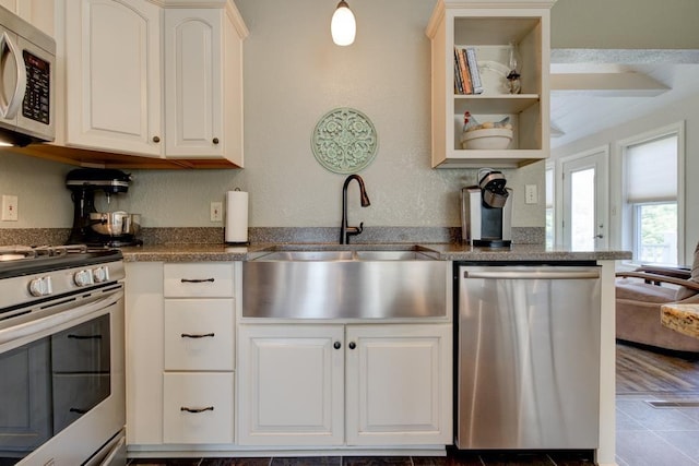 N5071 Deer Trl, Marinette, WI 54143 - kitchen featuring stainless steel appliances, a sink, white cabinets, dark countertops, and open shelves