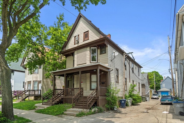 1718 W Washington St Unit 1720, Milwaukee, WI 53204 - american foursquare style home featuring covered porch and a chimney