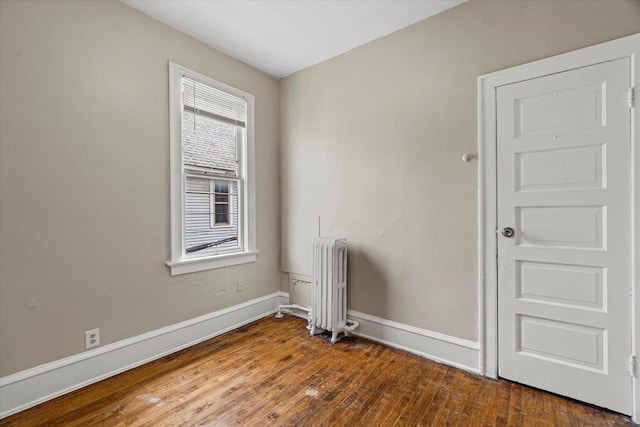 1718 W Washington St Unit 1720, Milwaukee, WI 53204 - spare room featuring radiator, hardwood / wood-style flooring, and baseboards