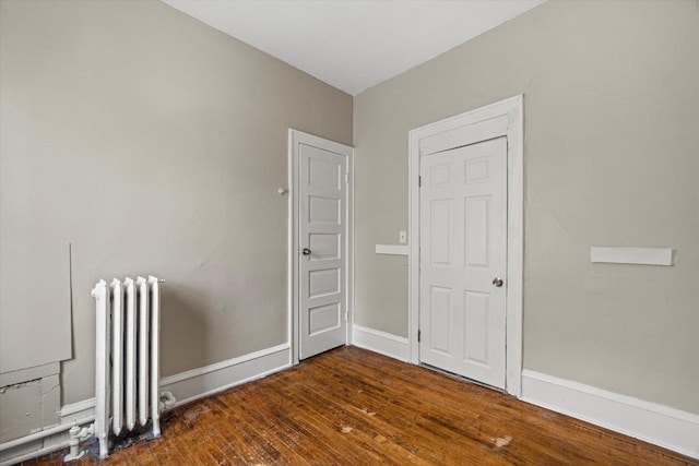 1718 W Washington St Unit 1720, Milwaukee, WI 53204 - empty room featuring radiator, wood-type flooring, and baseboards