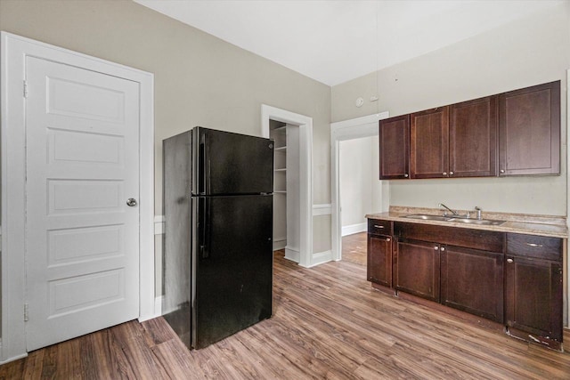 1718 W Washington St Unit 1720, Milwaukee, WI 53204 - kitchen featuring freestanding refrigerator, a sink, dark brown cabinets, and wood finished floors