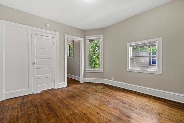 1718 W Washington St Unit 1720, Milwaukee, WI 53204 - unfurnished bedroom featuring baseboards and dark wood finished floors