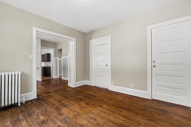 1718 W Washington St Unit 1720, Milwaukee, WI 53204 - unfurnished room featuring radiator, dark wood-type flooring, and baseboards
