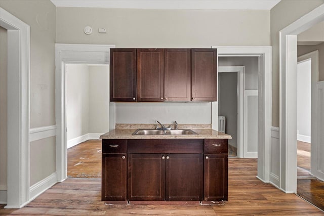 1718 W Washington St Unit 1720, Milwaukee, WI 53204 - kitchen featuring a sink, wood finished floors, dark brown cabinetry, and light countertops