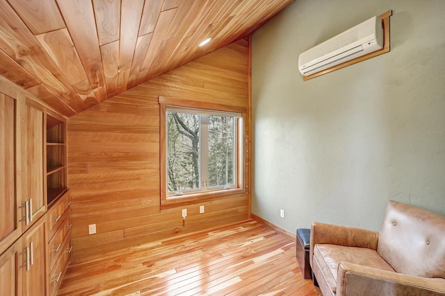 3857 Lake Lucerne Dr, Crandon, WI 54520 - living area featuring wood walls, vaulted ceiling, an AC wall unit, light wood-style floors, and wooden ceiling