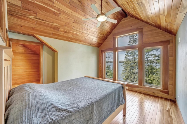 3857 Lake Lucerne Dr, Crandon, WI 54520 - bedroom with wood ceiling, vaulted ceiling, hardwood / wood-style flooring, wooden walls, and a ceiling fan