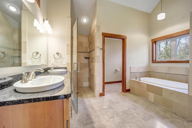 3857 Lake Lucerne Dr, Crandon, WI 54520 - full bathroom featuring double vanity, a stall shower, a bath, and lofted ceiling